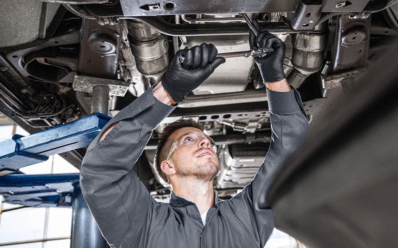 Roe Motors service technician working on vehicle